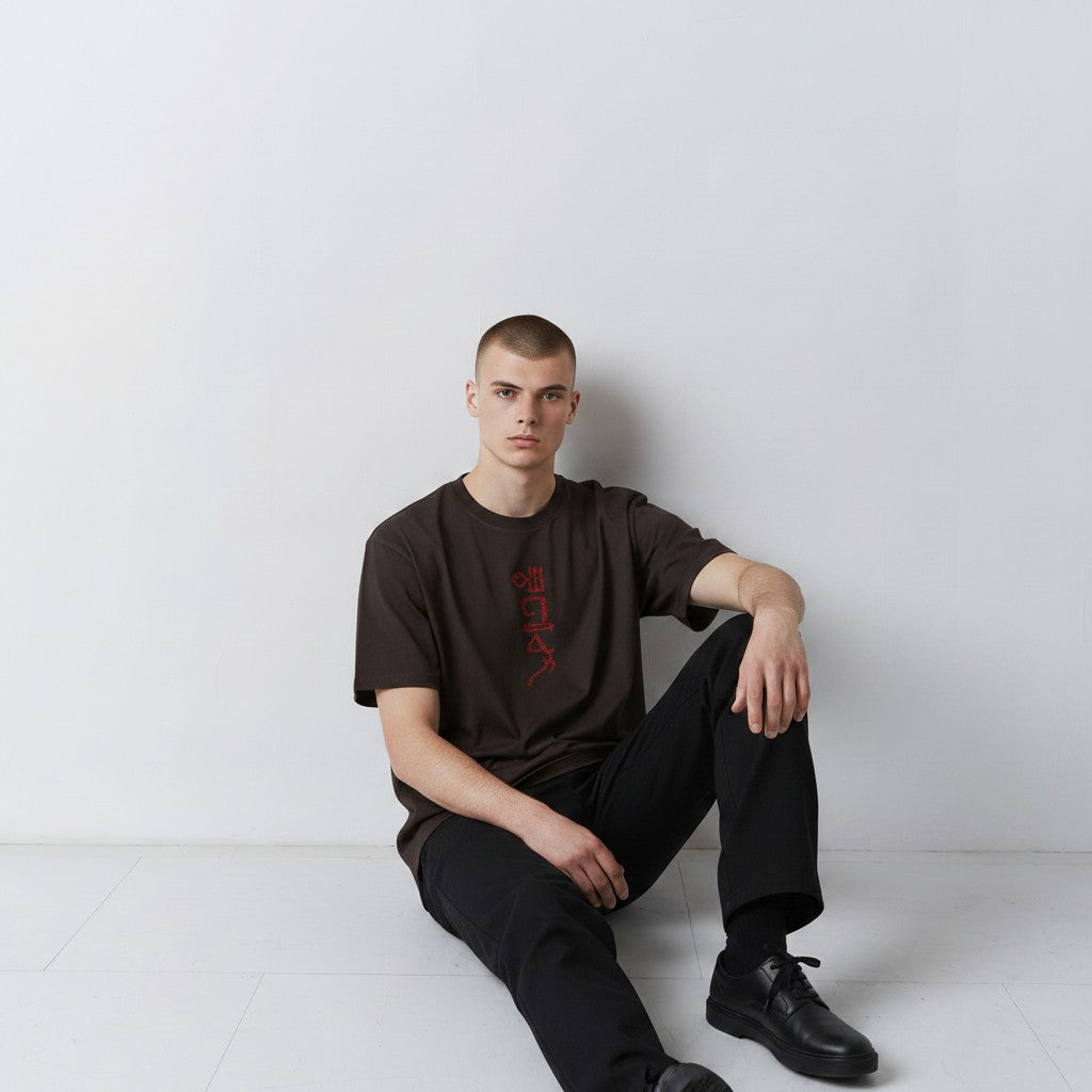 The Papyrus embroidered T-shirt in coal with hieroglyphic-style motif, alternate front view