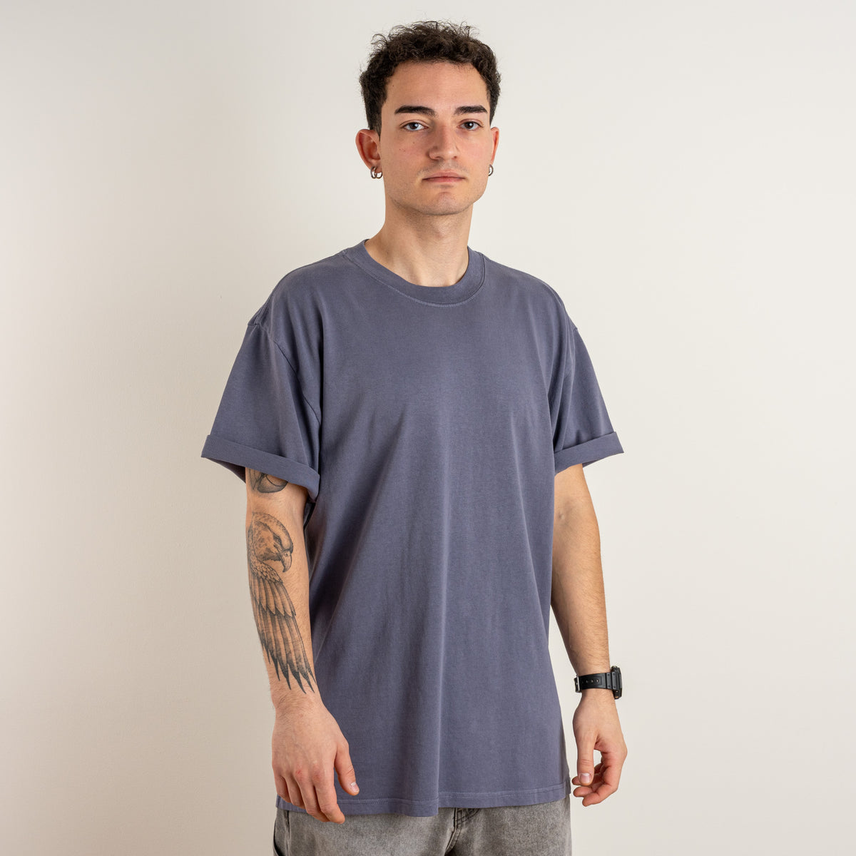 Front view of a model wearing the Gordina Unsigned Faded Indigo heavyweight cotton T-shirt, embroidered in the Netherlands.