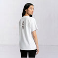 Load image into Gallery viewer, Water and Garden white T-shirt with burgundy cuneiform embroidery, model back view
