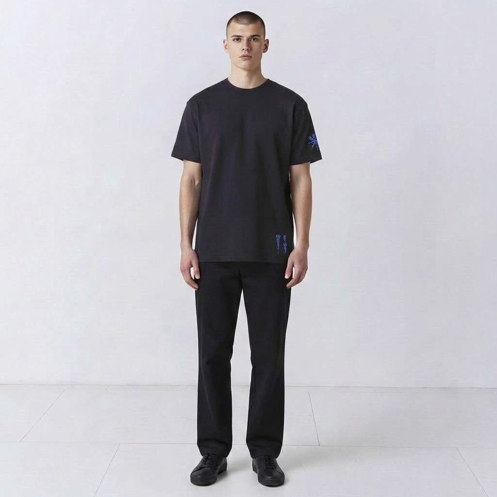 Front view of the Water and the Star navy T-shirt on a model, star embroidery on sleeve and water signs at the hem.