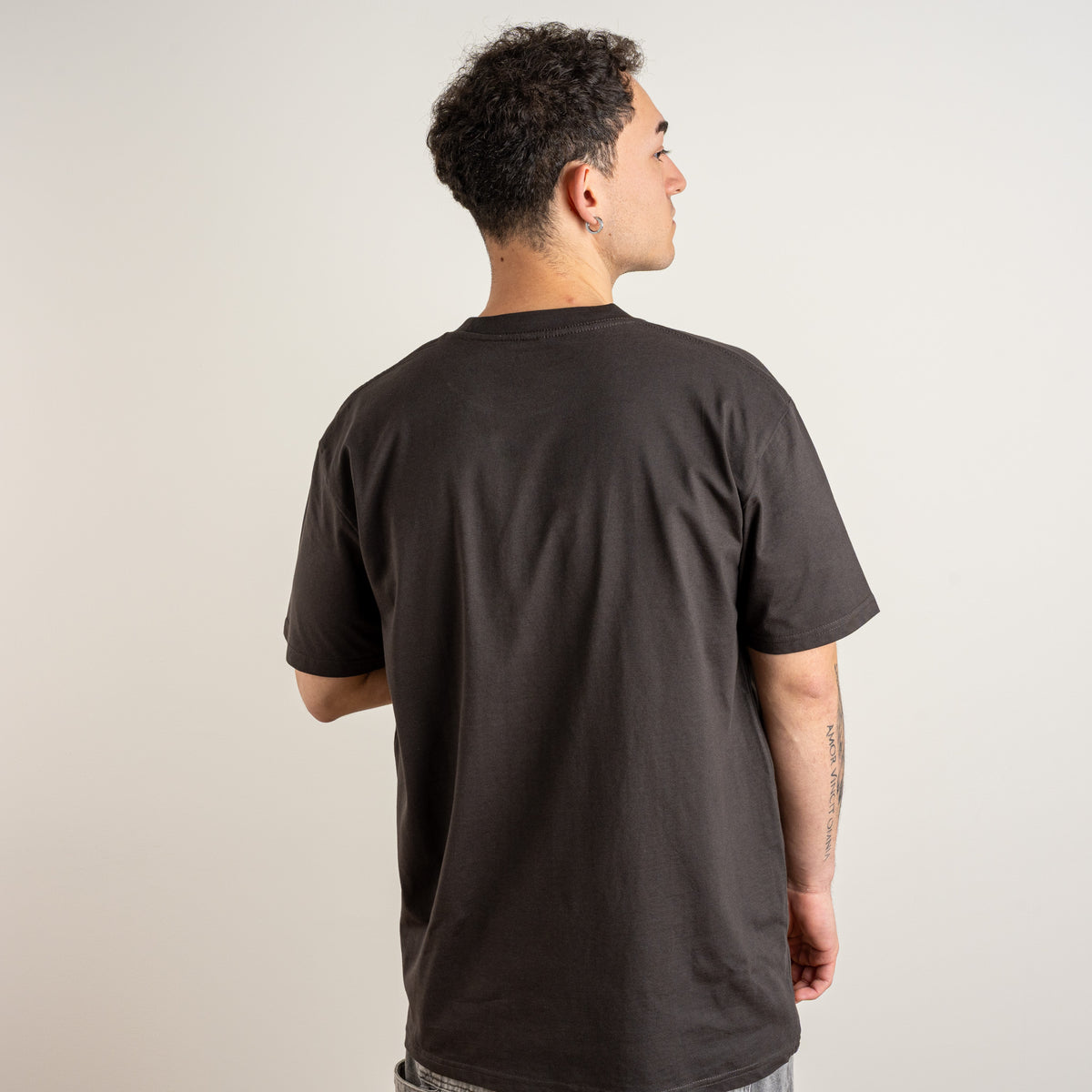 Back view of the Papyrus coal T-shirt on a model