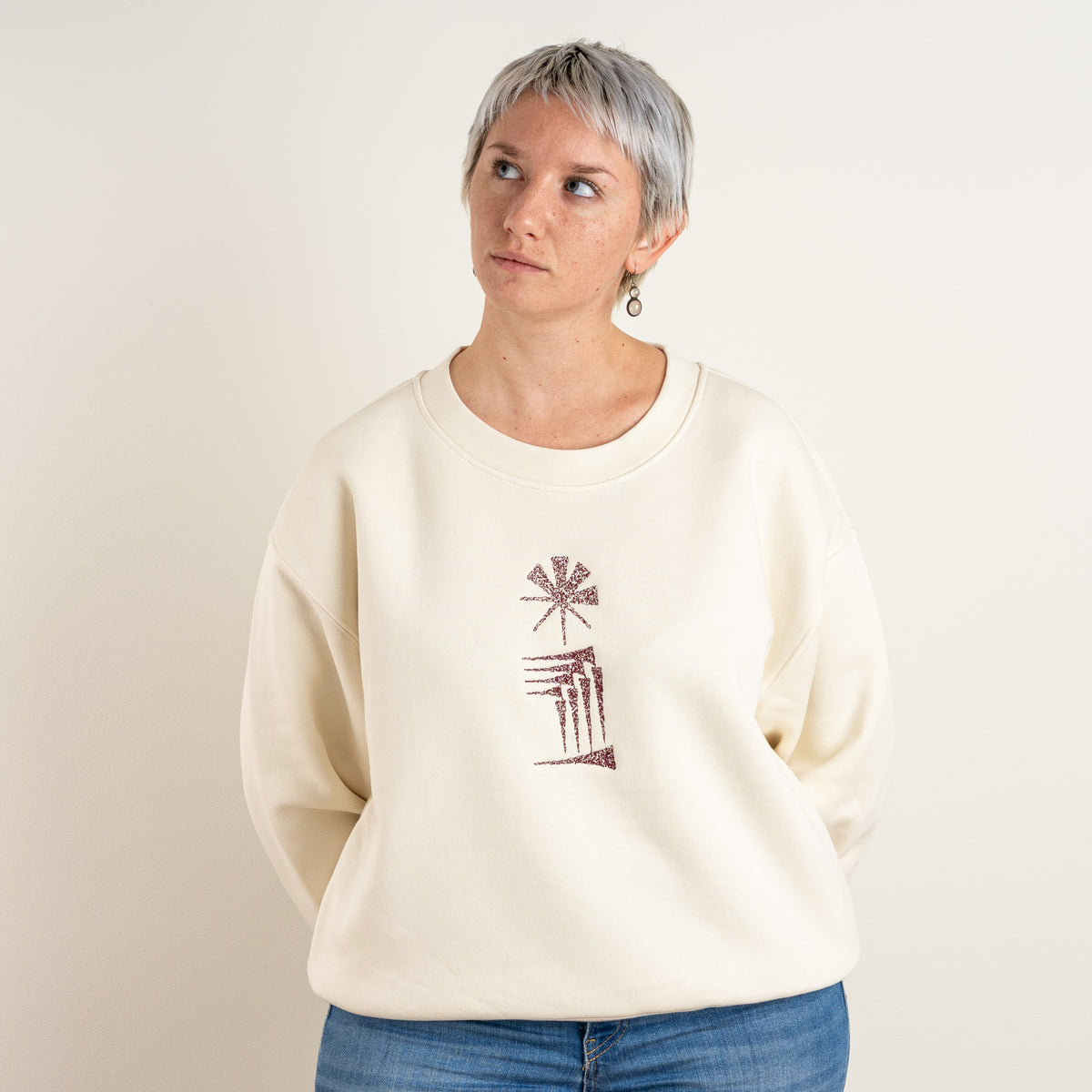 Front view of the ecru Star and House sweatshirt with chest embroidery