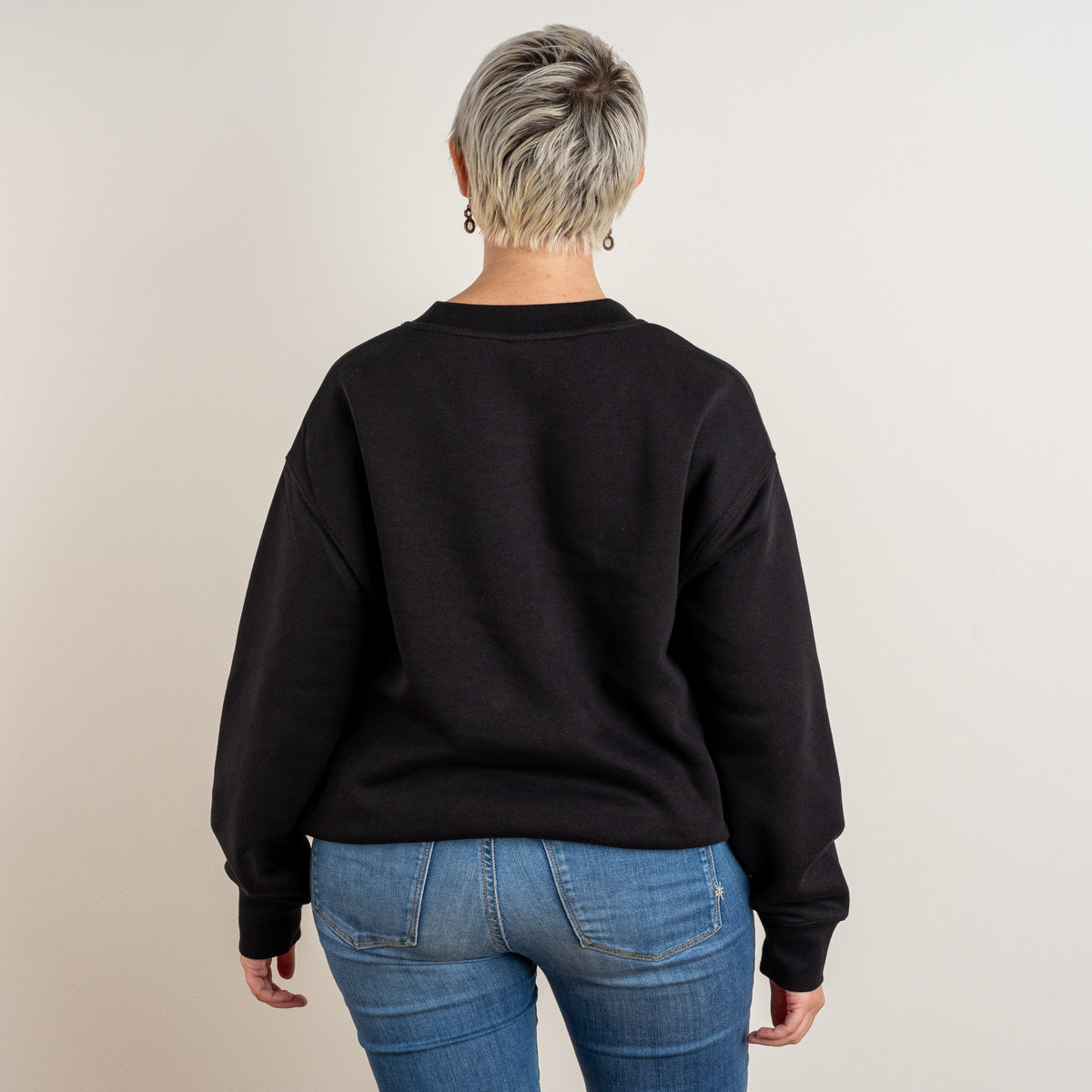 Back view of the black Papyrus sweatshirt on a model