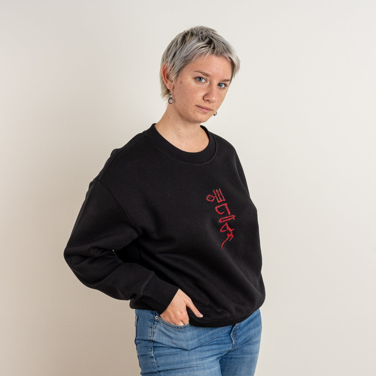 Three-quarter view of the black Papyrus embroidered sweatshirt on a model