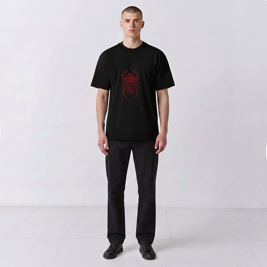 Front view of a model wearing the black Gordina Scarab T-shirt with centered red embroidery.