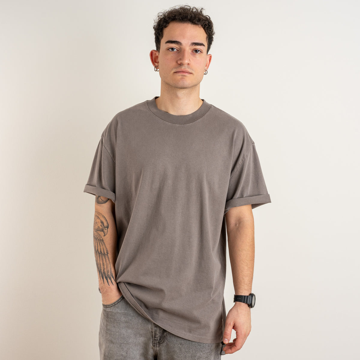 Model wearing the Gordina The Scarab faded grey heavyweight cotton T-shirt, front view.