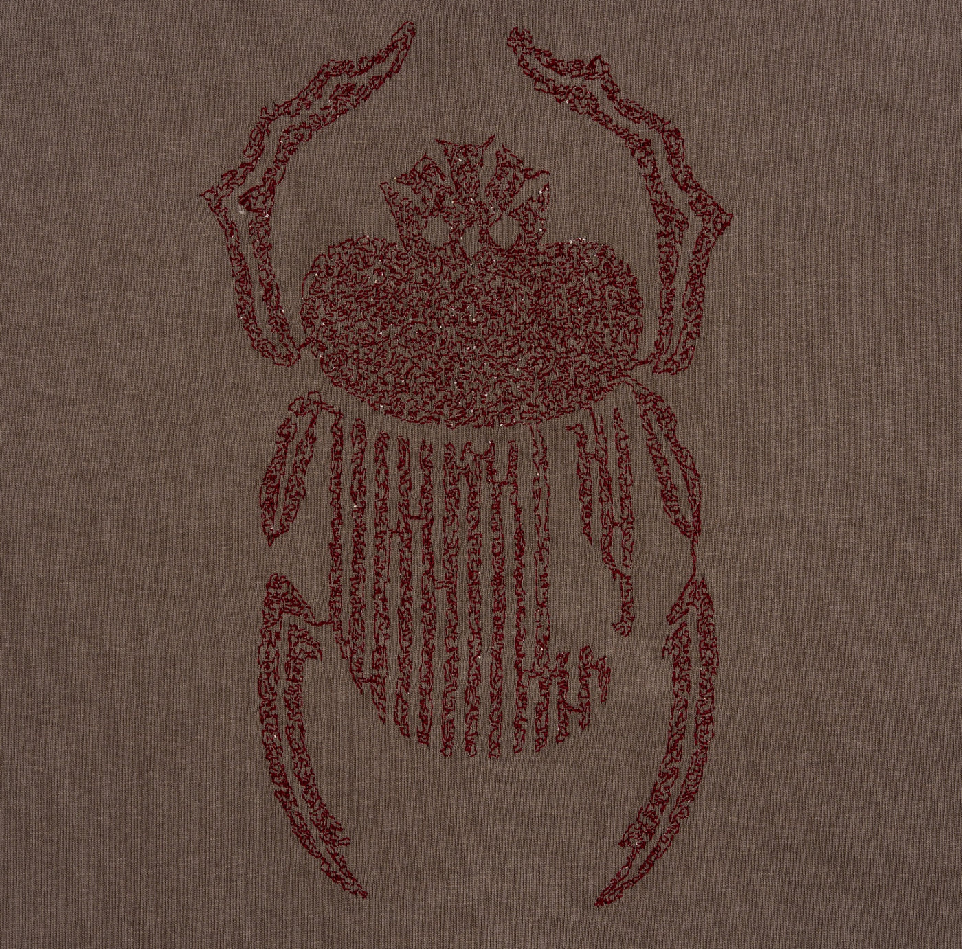 Close-up of burgundy scarab embroidery on the Gordina grey heavyweight cotton T-shirt.