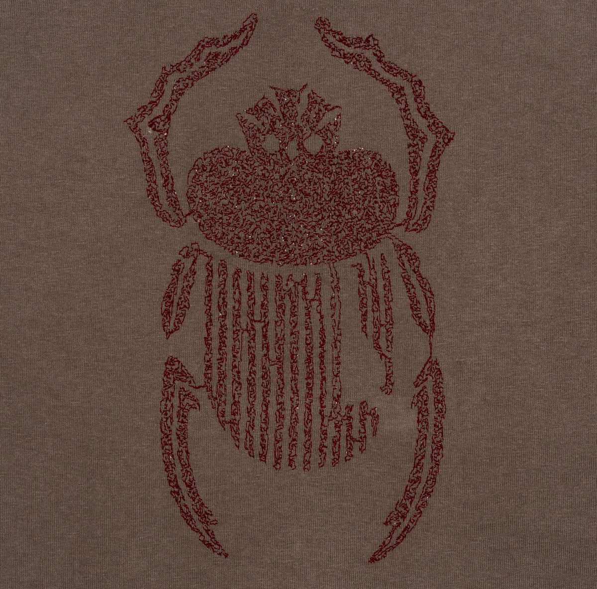 Close-up of burgundy scarab embroidery on the Gordina grey heavyweight cotton T-shirt.