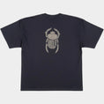 Load image into Gallery viewer, Flat lay of the Gordina The Scarab navy oversized T-shirt with ivory scarab embroidery placed on the back.
