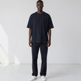 Load image into Gallery viewer, Front view of a model wearing the Gordina navy 5069 oversized cotton T-shirt.
