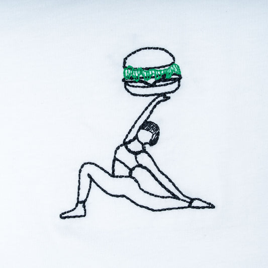 Close-up of white organic cotton t-shirt with yoga figure holding burger embroidery, Gordina