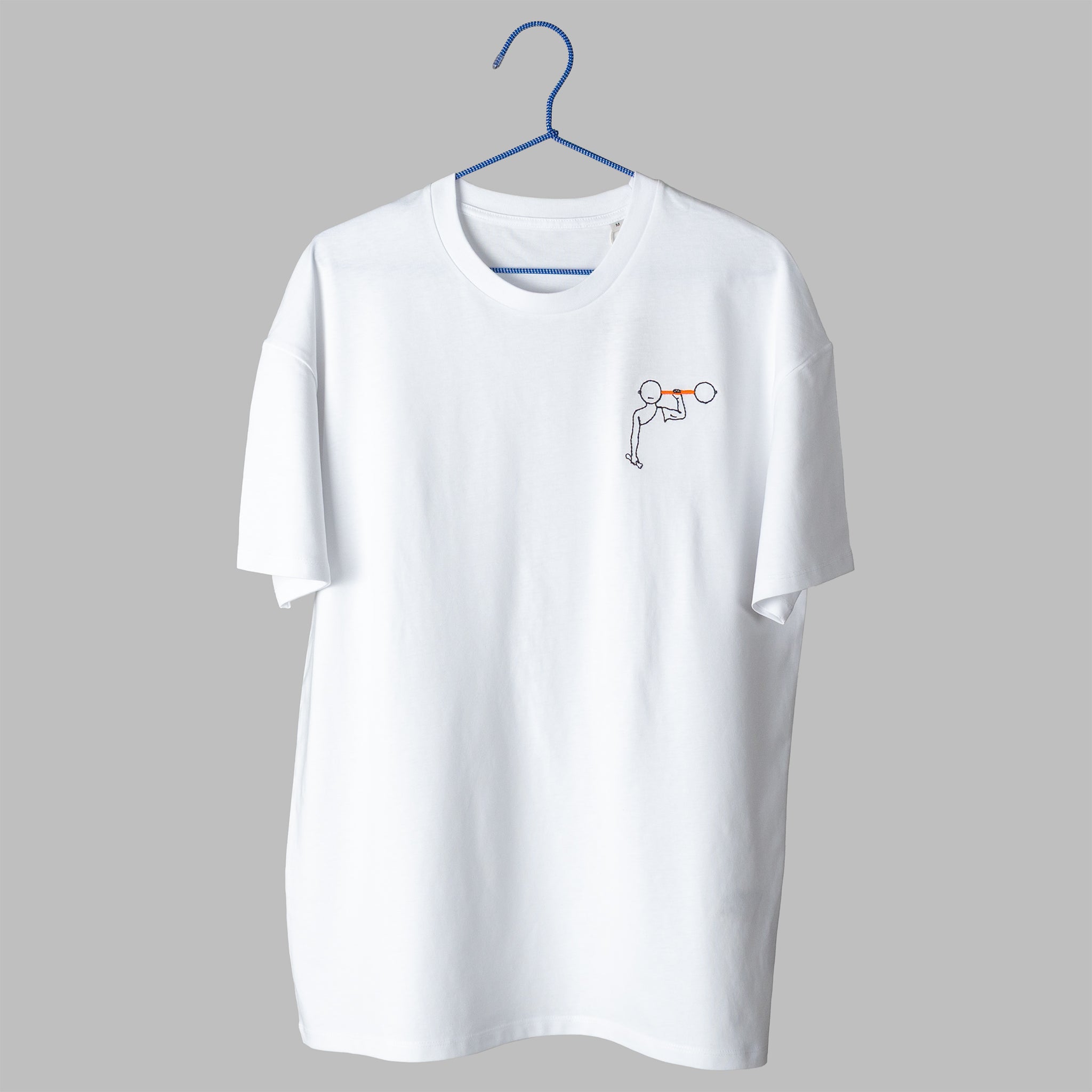A white t-shirt on a blue wire hanger against a light grey background. It features a small embroidered design on the left chest depicting a simple black line-art figure lifting an orange barbell over their head.