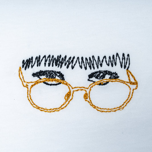 Close-up of white organic cotton t-shirt with embroidered glasses and fringe detail, Gordina