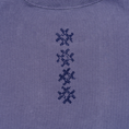 Load image into Gallery viewer, Close-up of vertical navy cross embroidery on the Gordina Unsigned faded indigo cotton T-shirt.

