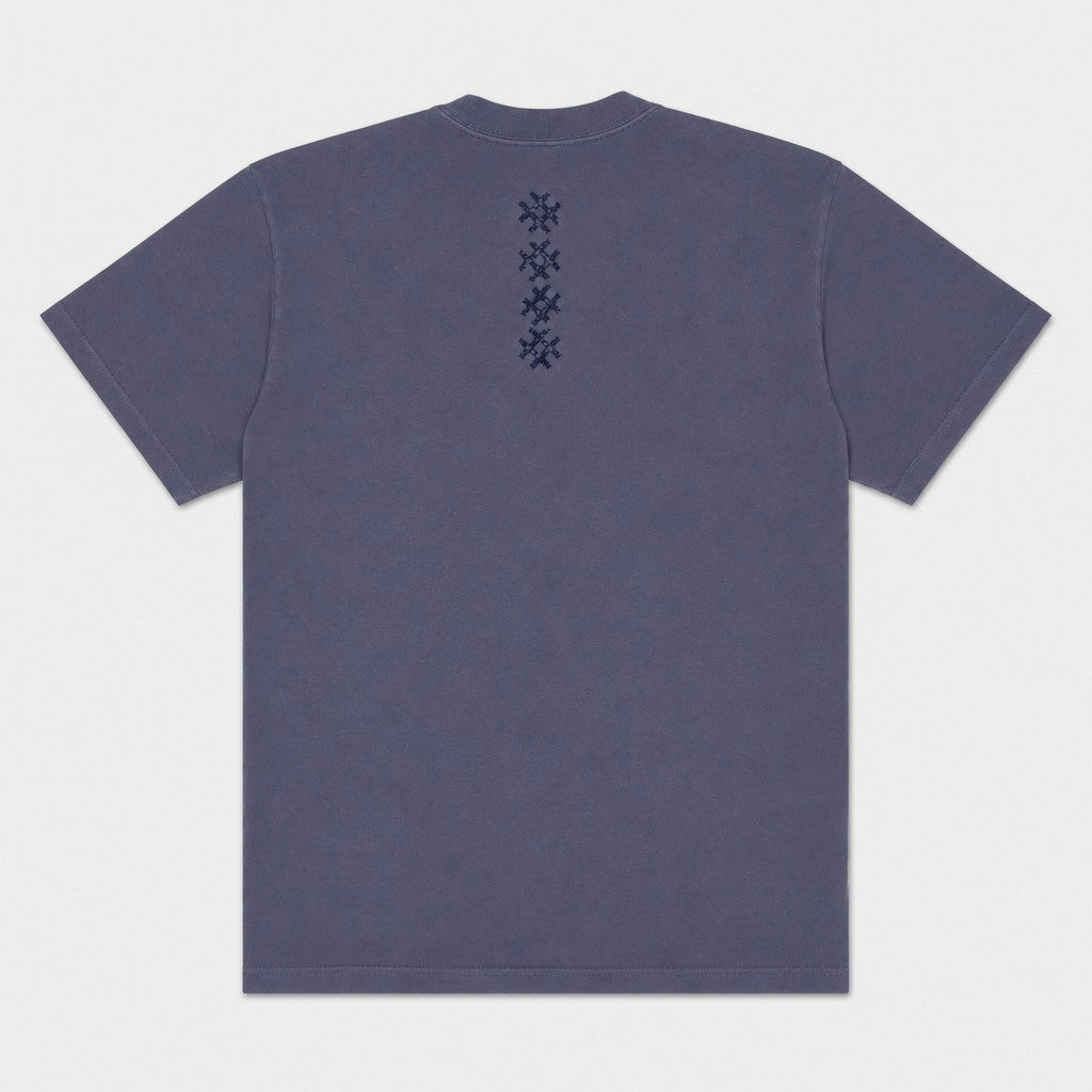 Back flat lay of the Gordina Unsigned faded indigo T-shirt with vertical navy cross embroidery.