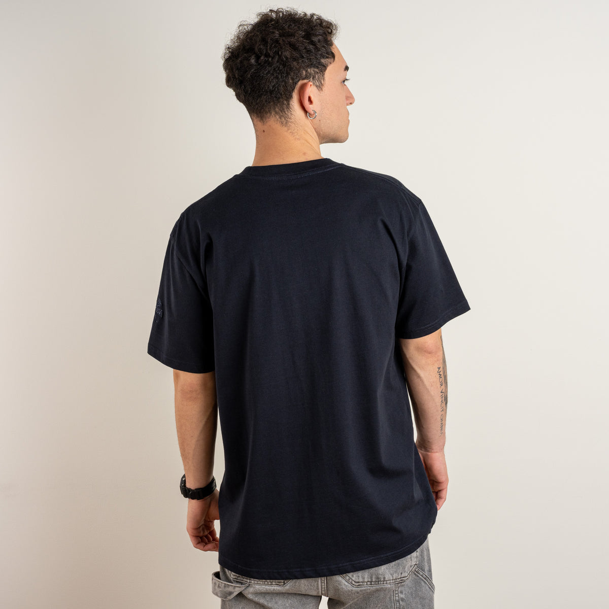 Back view of a model wearing the Gordina Water and the Star navy cotton T-shirt.